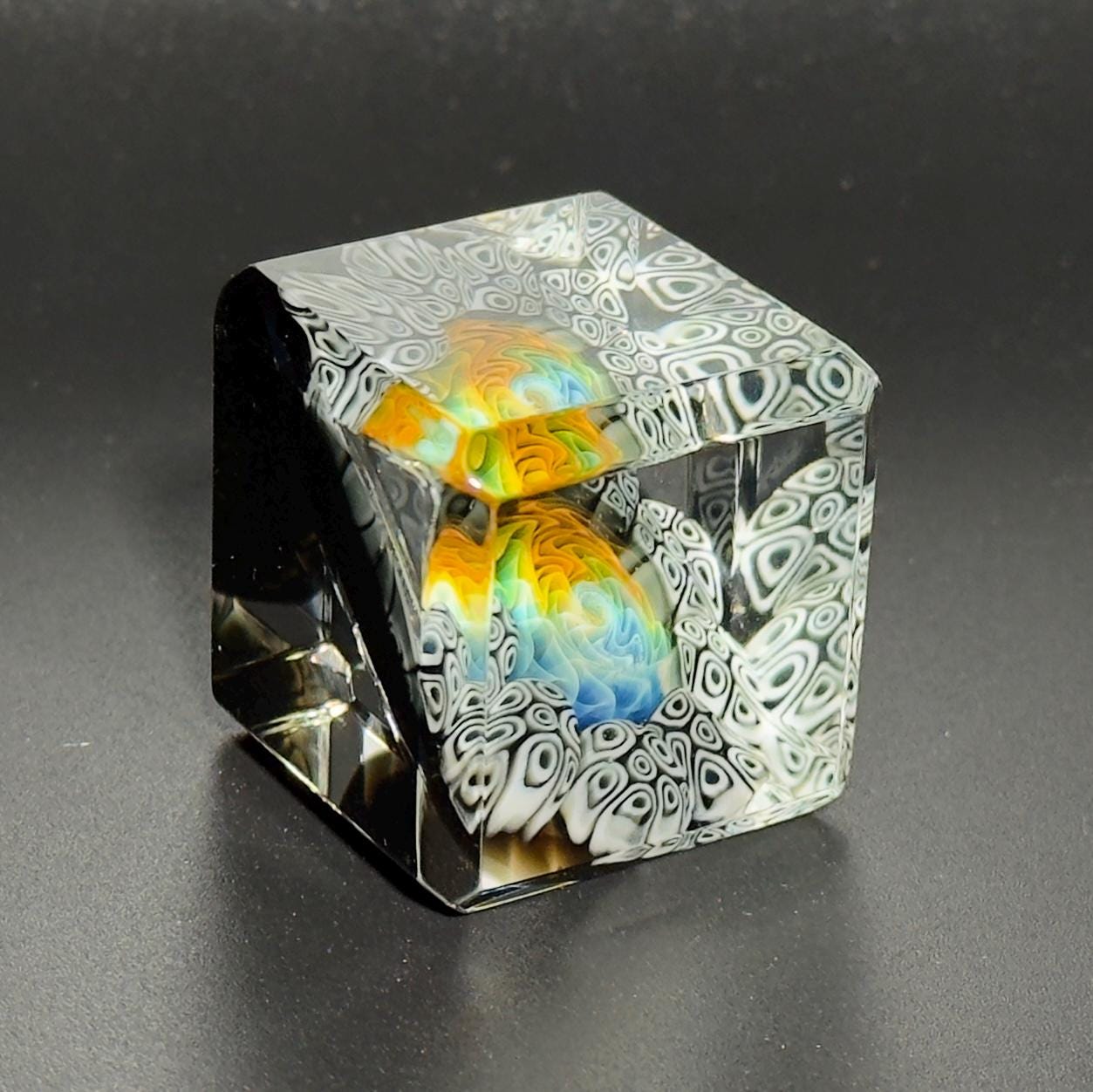 Blown glass cube with black and white murrine surrounding fume linework, 40mm