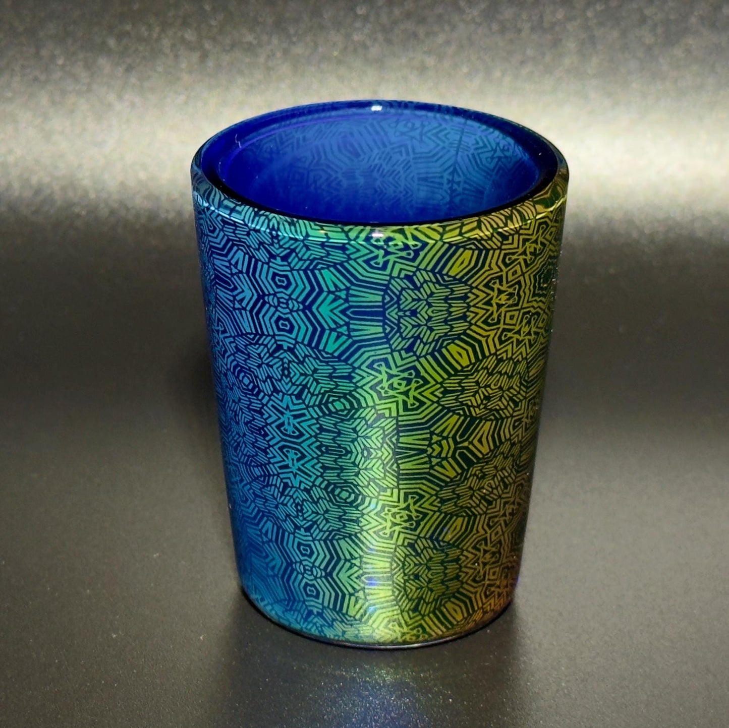 Fume pattern hand blown glass shot cup - vibrant color changing fume gradient over blue