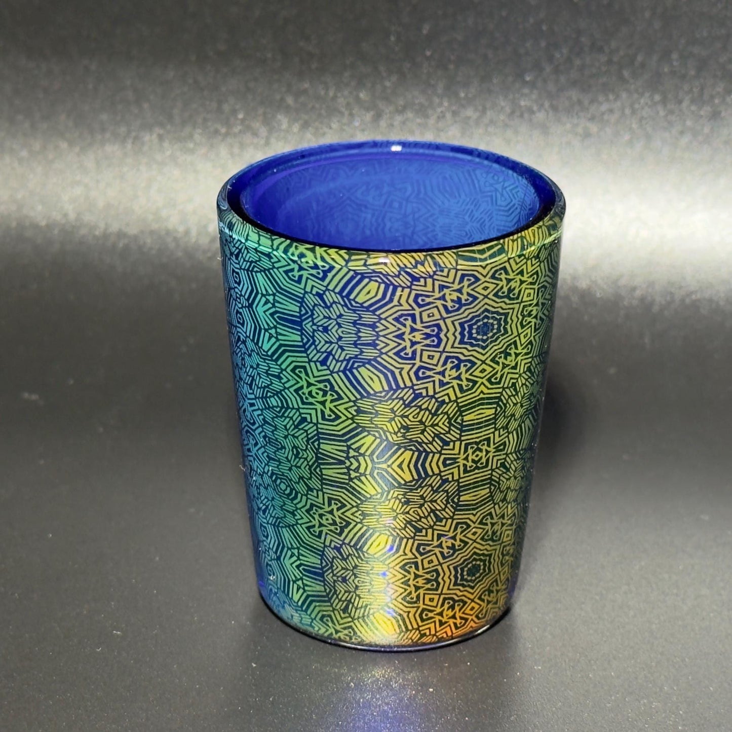 Fume pattern hand blown glass shot cup - vibrant color changing fume gradient over blue