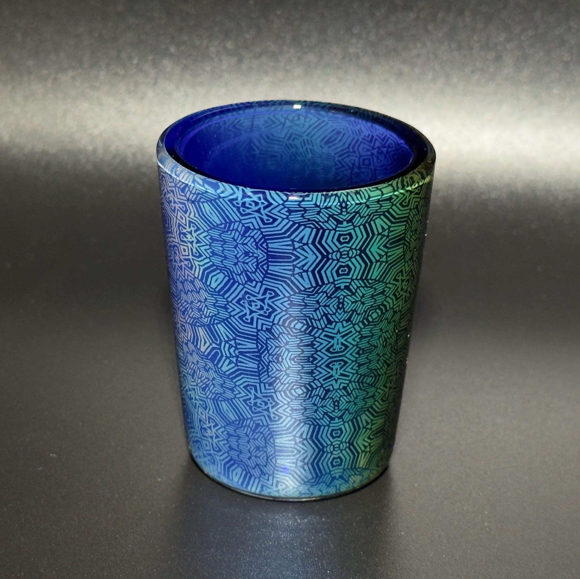 Fume pattern hand blown glass shot cup - vibrant color changing fume gradient over blue