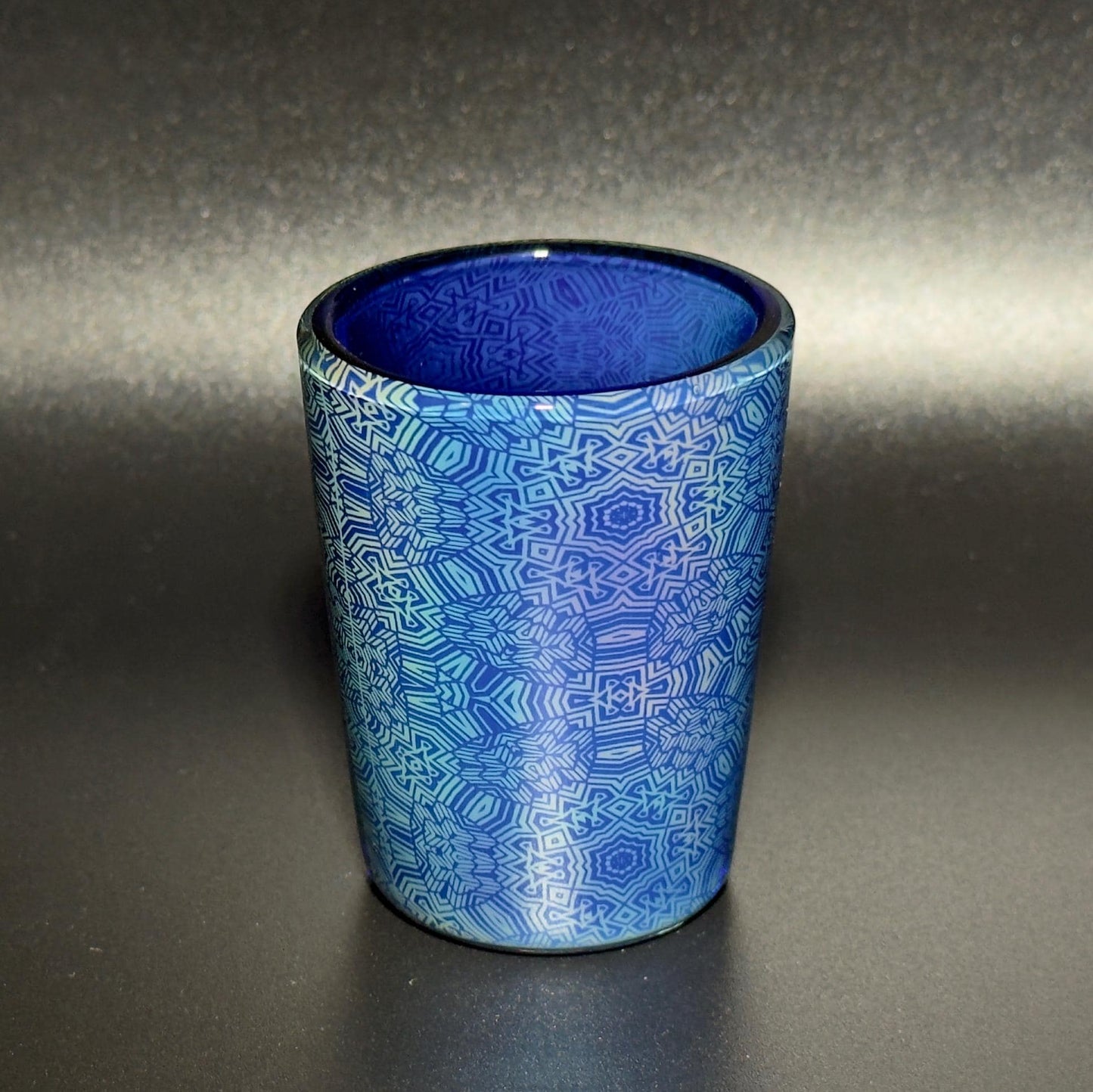 Fume pattern hand blown glass shot cup - vibrant color changing fume gradient over blue