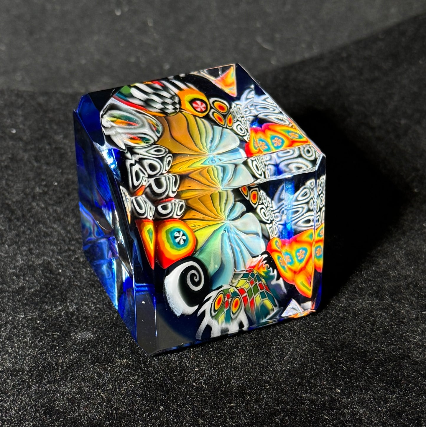 Fume murrini surround hand blown glass cube with cobalt backing