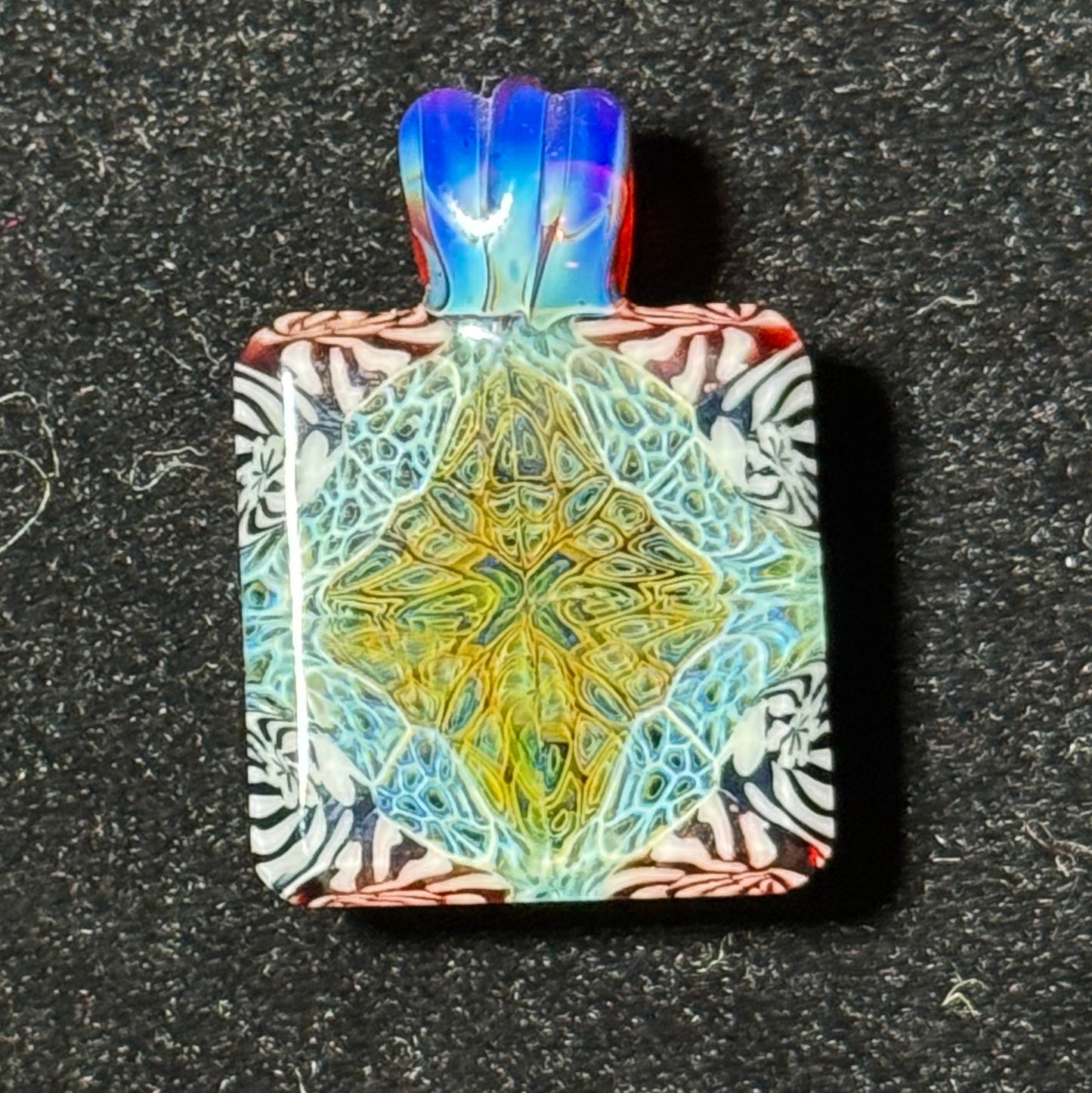 Murrine chip stack hand blown glass pendant with black backing and amber purple bale