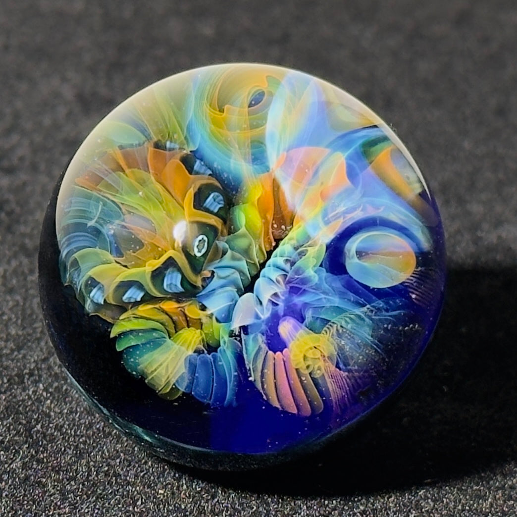 Fumescape implosion blown glass marble with neptunium swirl backing, 36mm