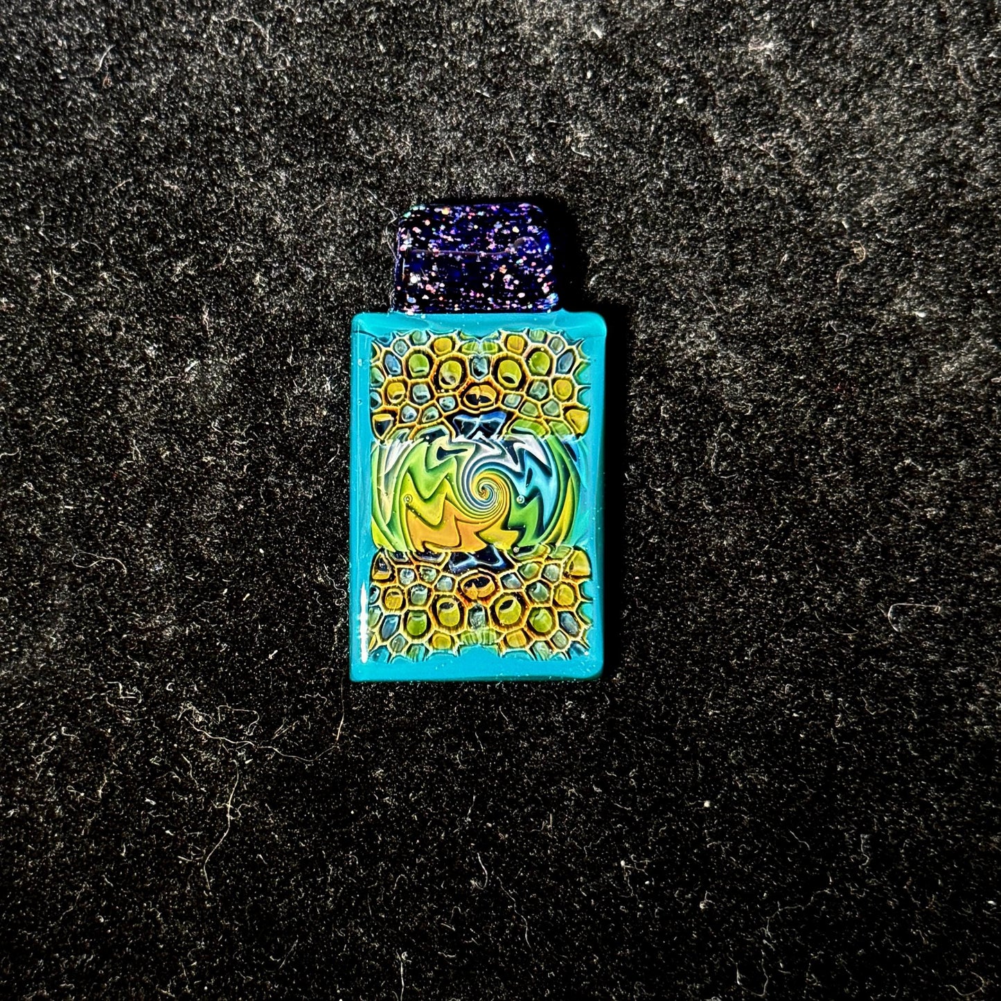 Fume murrine wiggy stacker pendant with peacock blue surround and crushed opal over cobalt bail